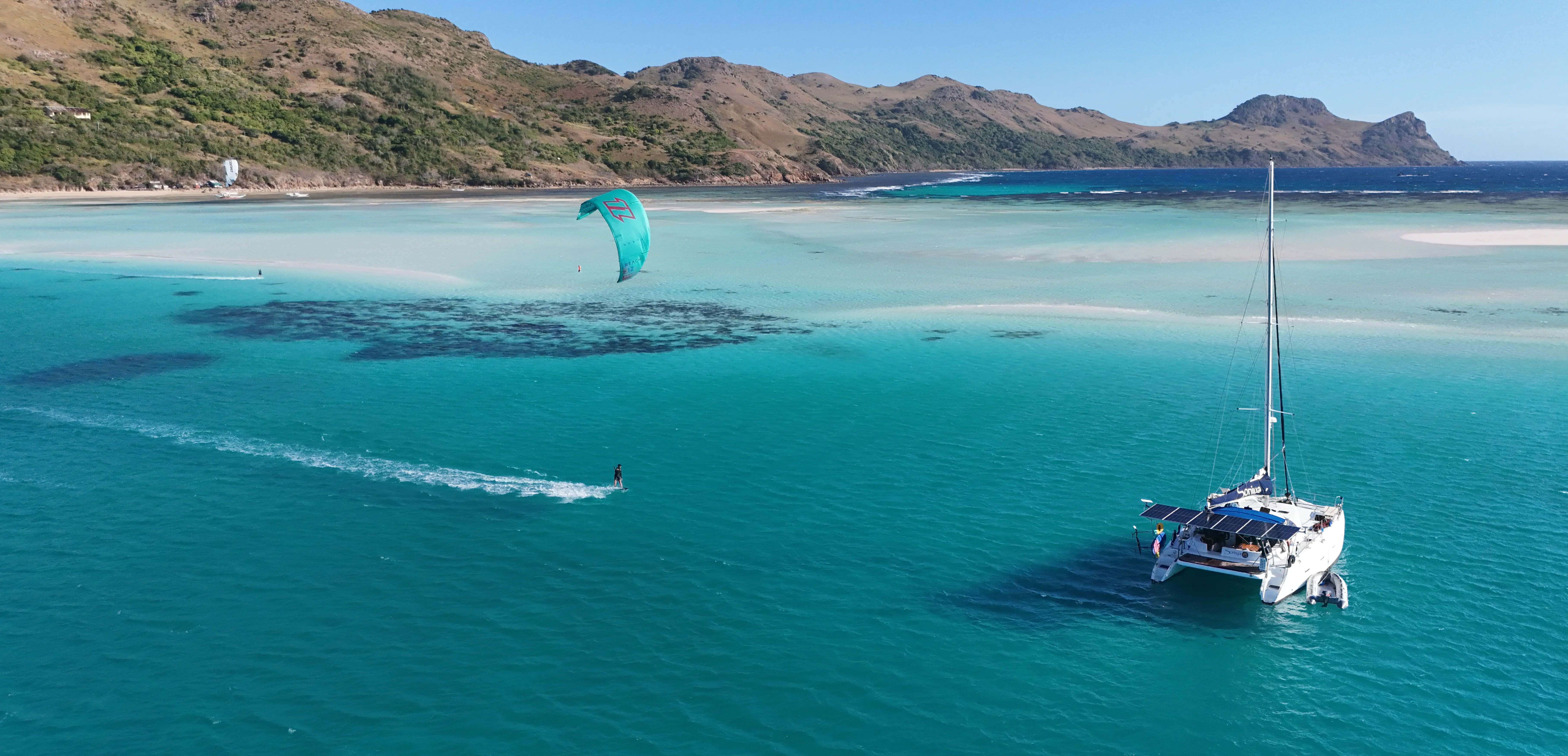 Soniya catamaran anchored in turquoise lagoon waters, Philippines